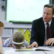 Britain's Prime Minister David Cameron reads a book to Lucy Howarth, 6, and Will Spibey, 5, left, during a visit to Sacred Heart RC primary school in Westhoughton near Bolton, England, Wednesday, April 8, 2015.